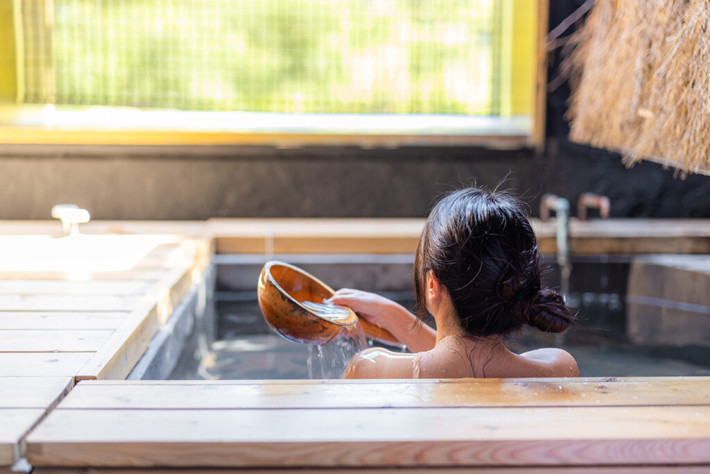 Woman enjoy the onsen in bathtub at resort